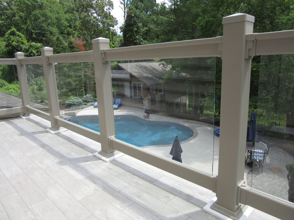 railing beside a deck overlooking a pool
