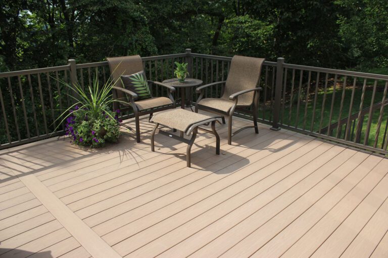A vinyl deck with aluminum railing, patio furniture, and plants.