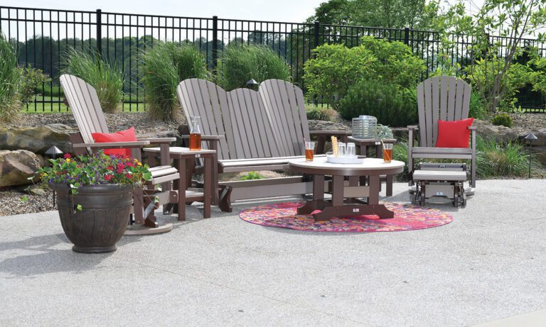 Brown comfo-back chairs and a glider surround a table with glasses of iced tea.