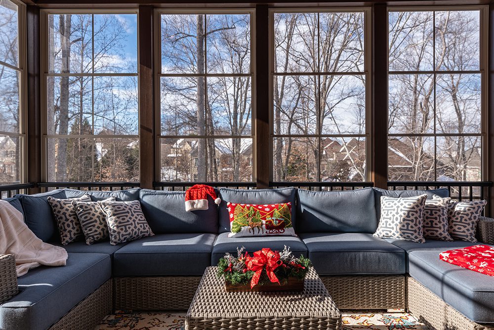 A screened-in porch is decorated for Christmas.