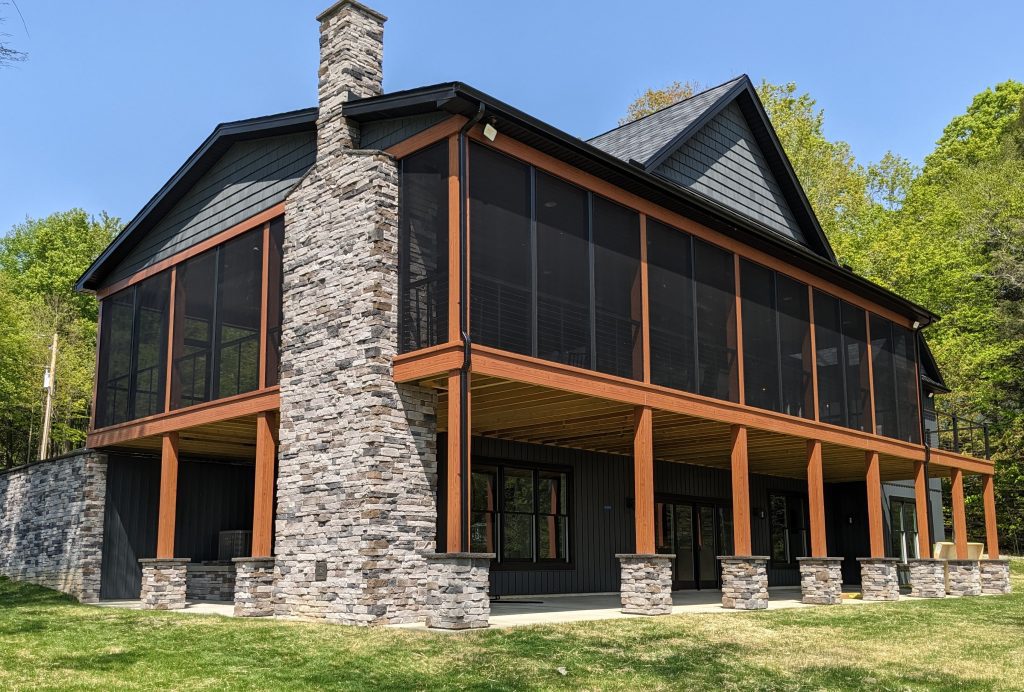 a 2-story home with a screened-in deck